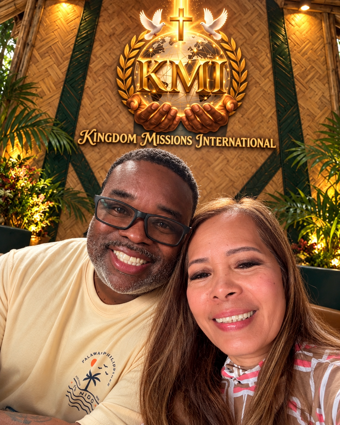 Brother Marc and Sister Helen pictured together beneath the Kingdom Missions International emblem