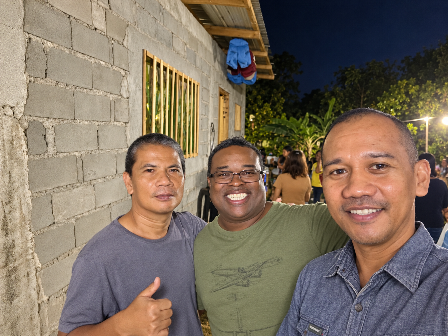 Brother Marc with two fellow ministry partners at an evening gathering