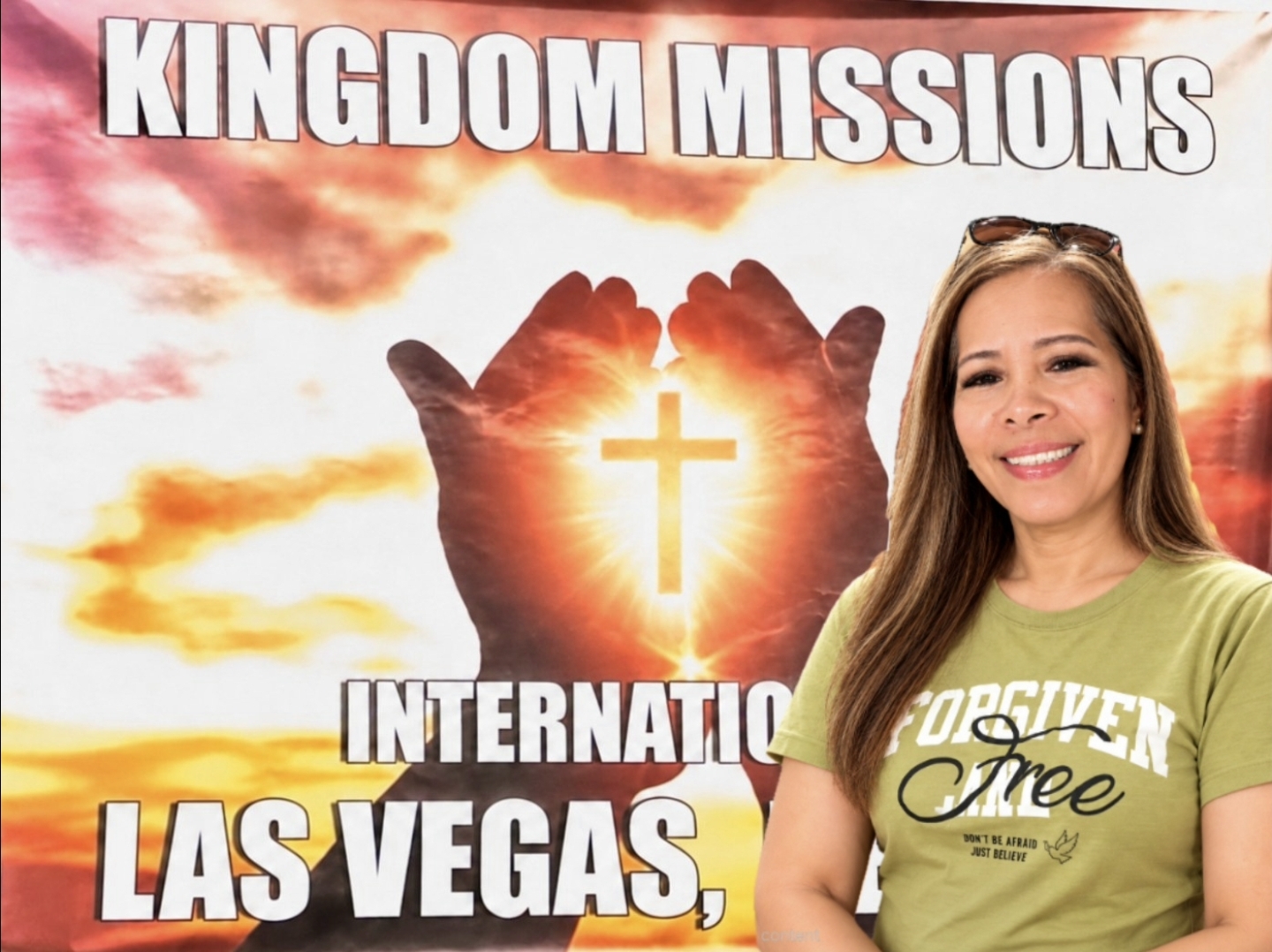 Sister Helen smiling in front of the Kingdom Missions International Las Vegas ministry banner